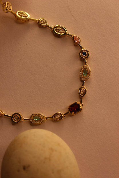 Solstice Waltz Necklace on a yellow background