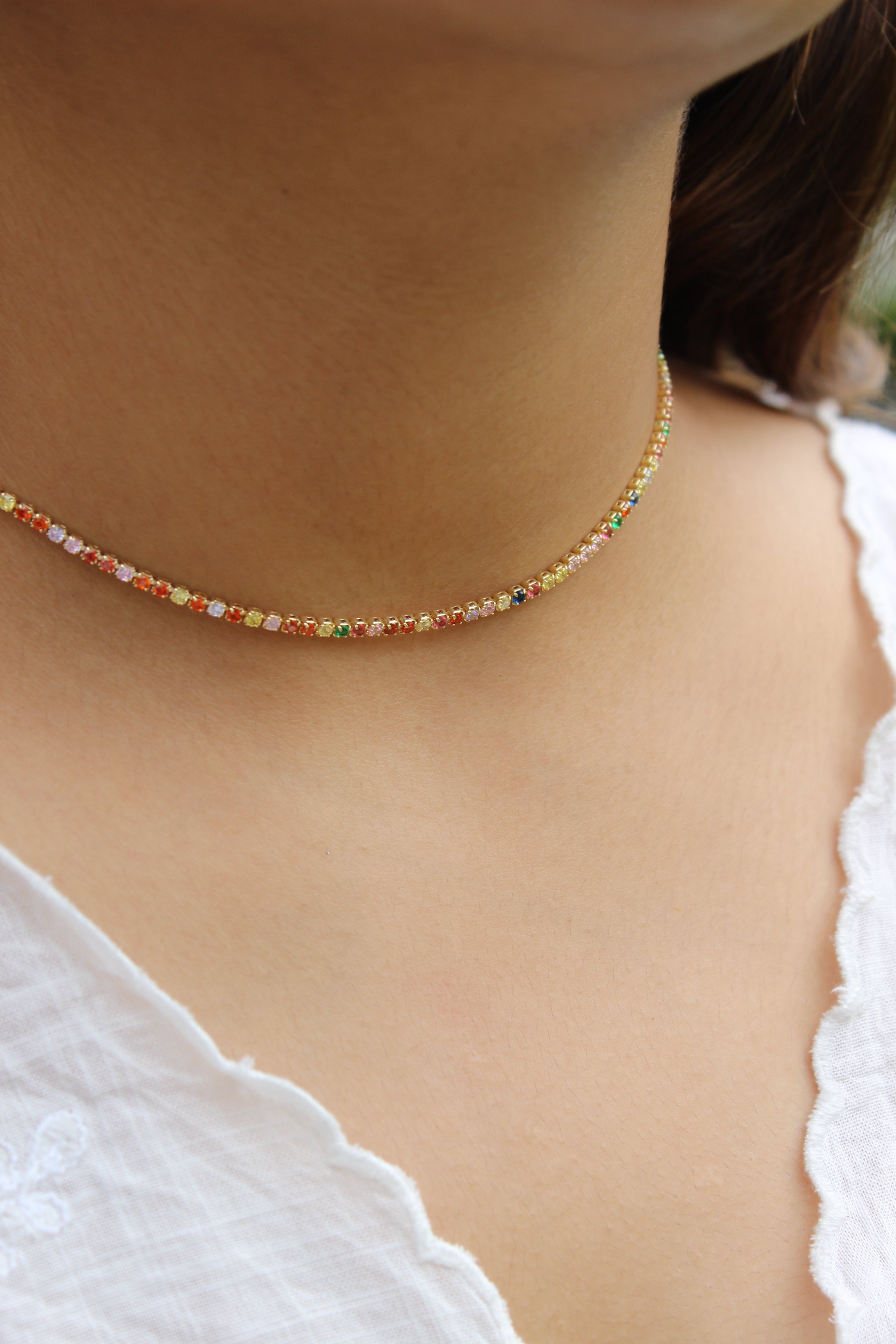 Colorbind Necklace on a model's neck with a blurred background