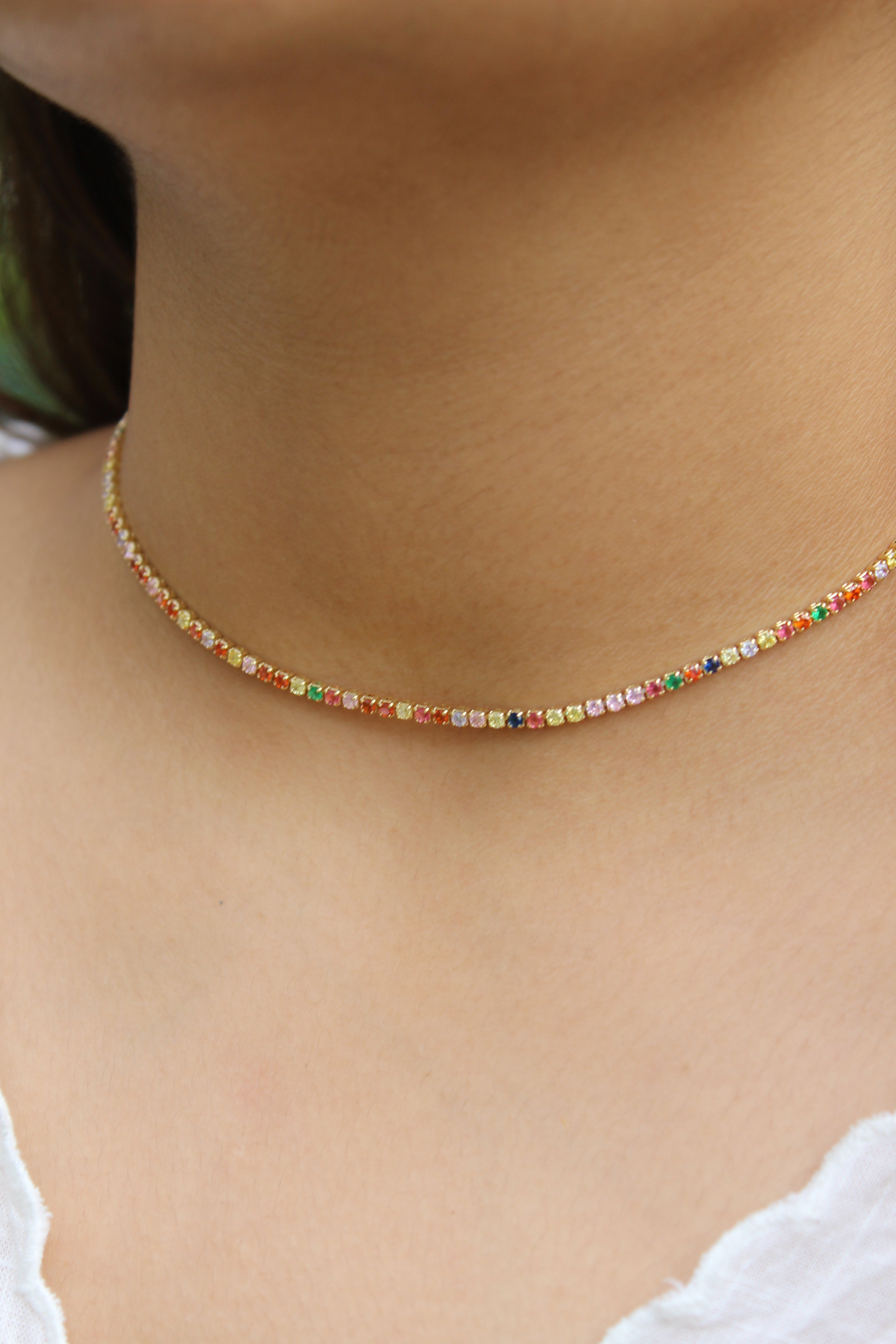 Colorbind Necklace on a model's neck with a blurred background