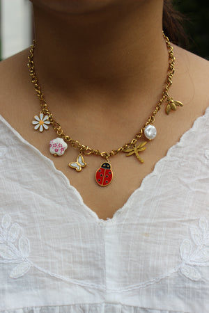 Bloom Folk Charms Necklace on a model's neck
