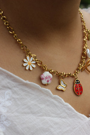 Close-up of Bloom Folk Charms Necklace on a model's neck