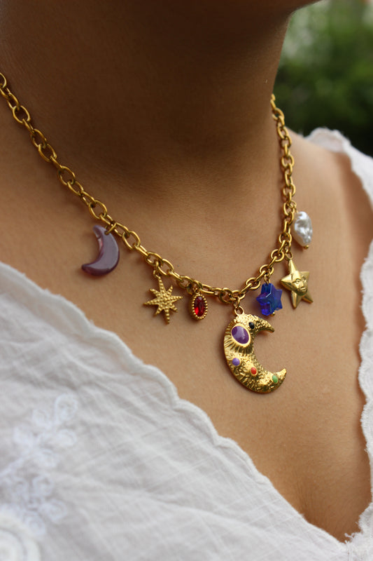 Lunar Spells Charms Necklace on a mode's neck against a white top