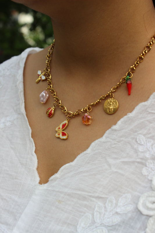 Woman wearing Wild Keepsake Charms Necklace with colorful pendants on a white lace dress