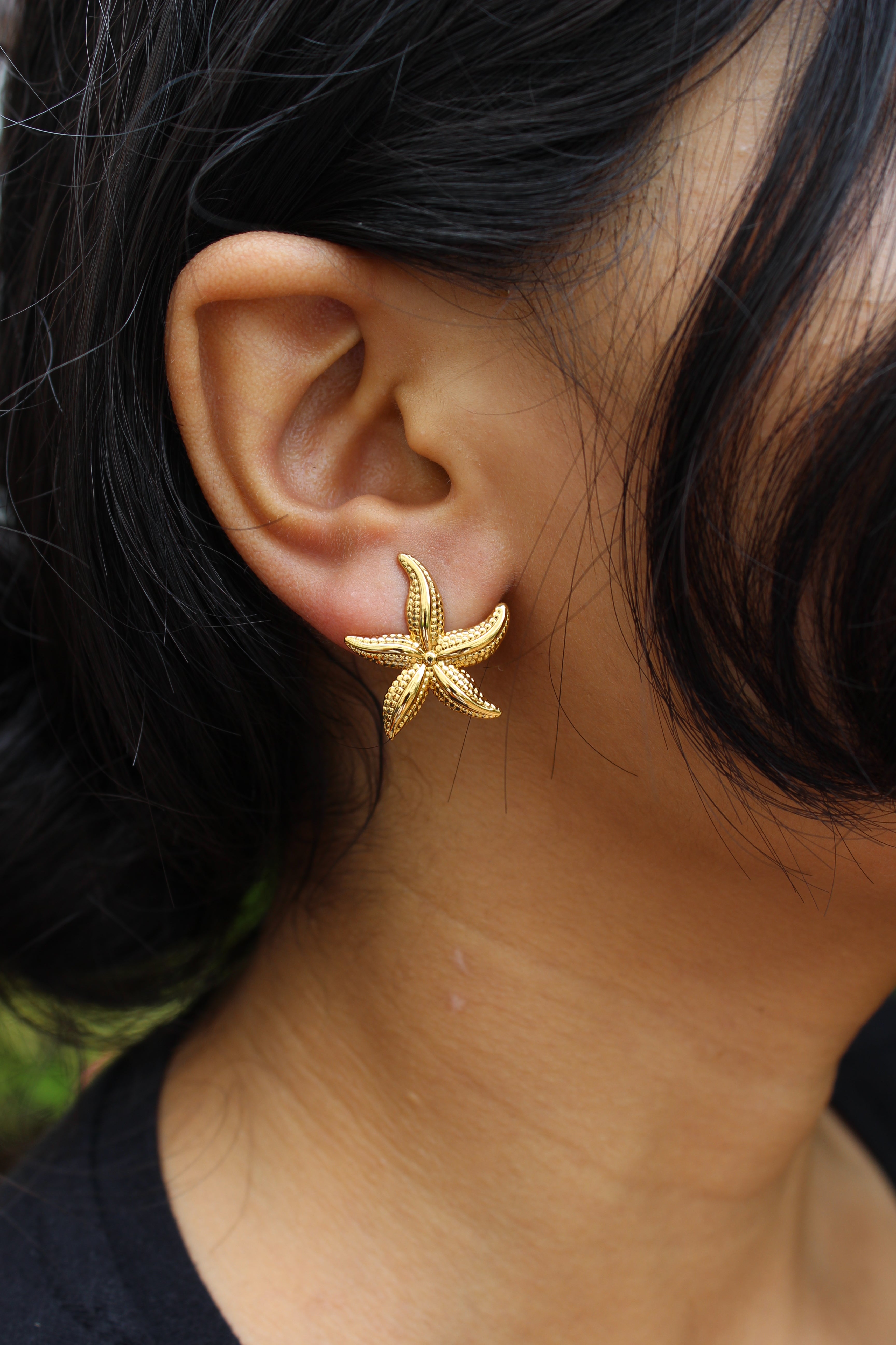 Close-up of a model wearing a Solstar Stud Earrings with dark hair