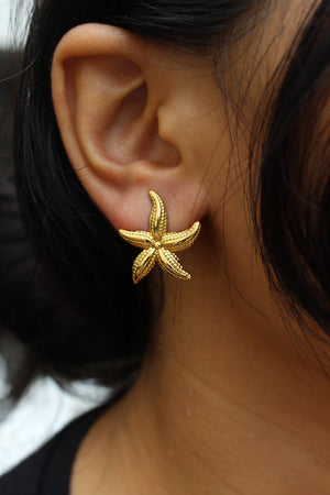 Close-up of a model wearing a Solstar Stud Earrings