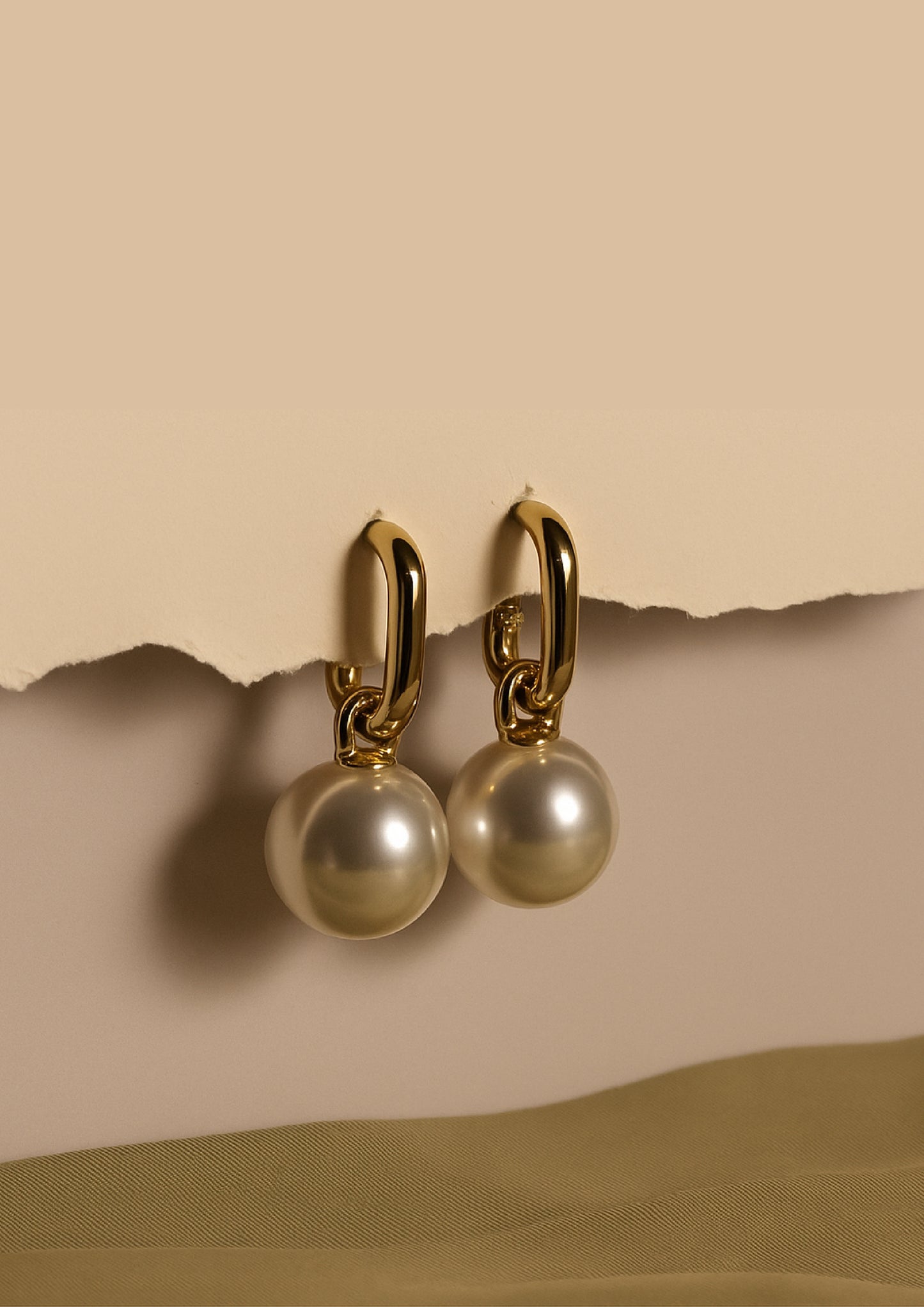 Luna Pearla Earrings with pearls on a beige background