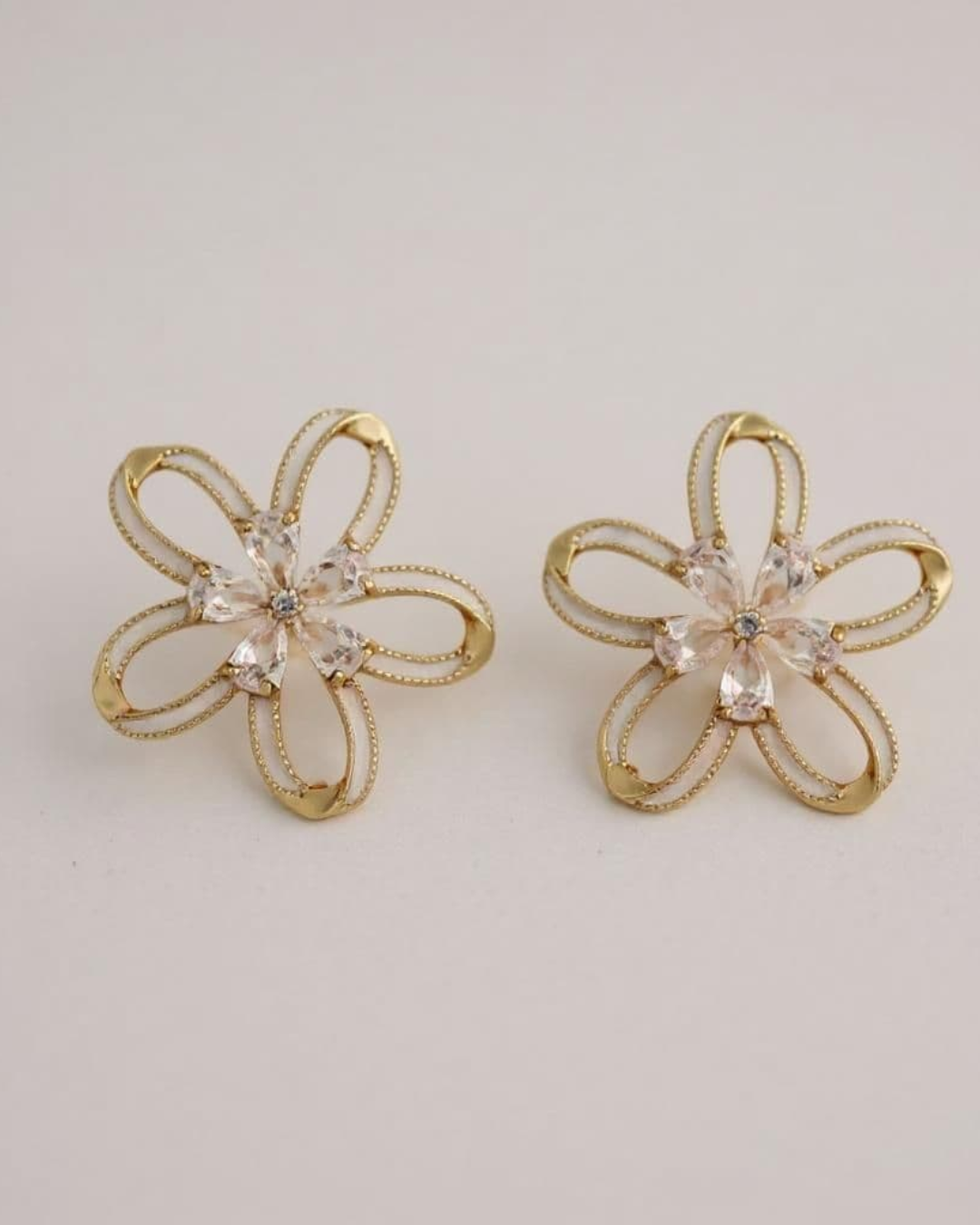 Frost Bloom Stud Earrings on a light gray background