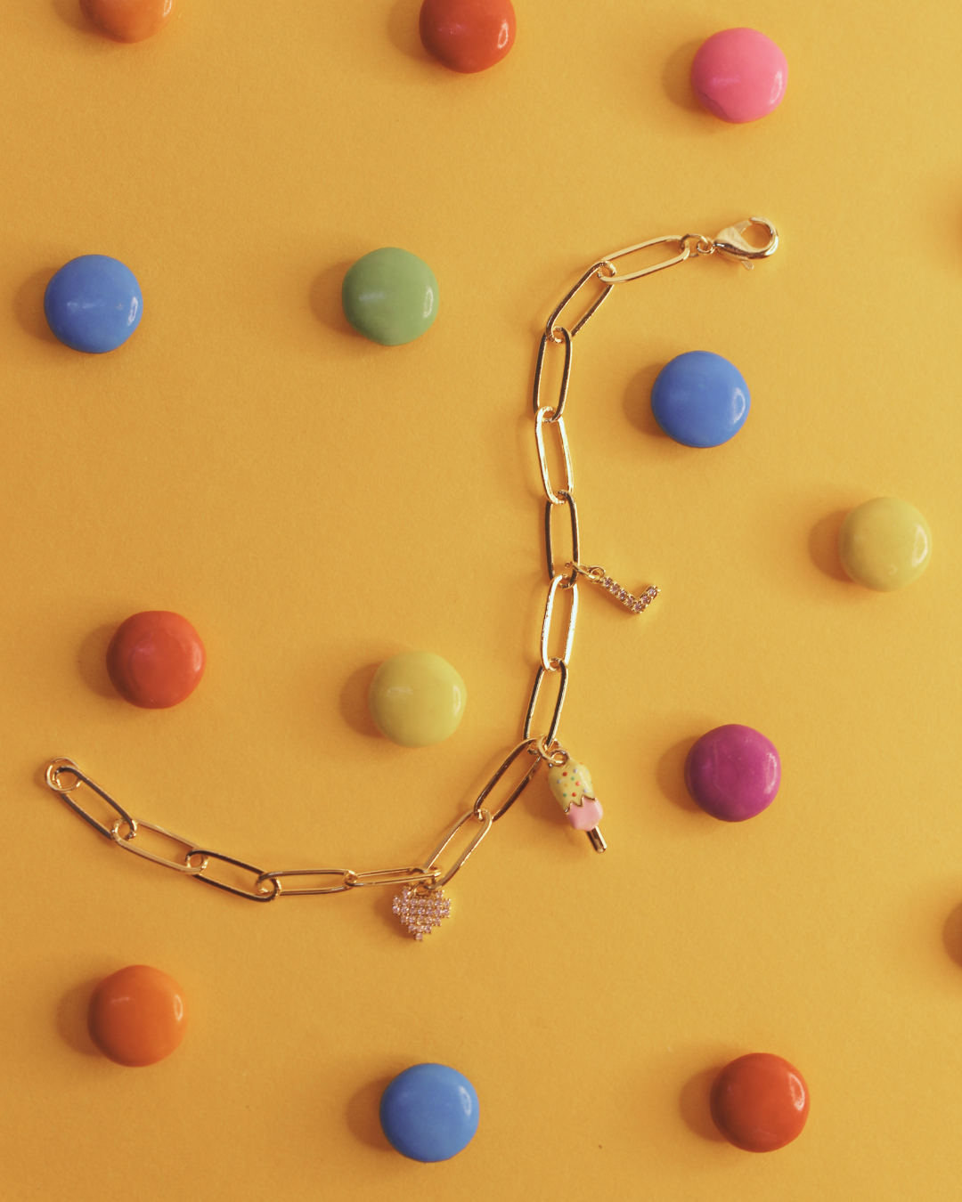 Sugar Links Charm Bracelet on a yellow background 