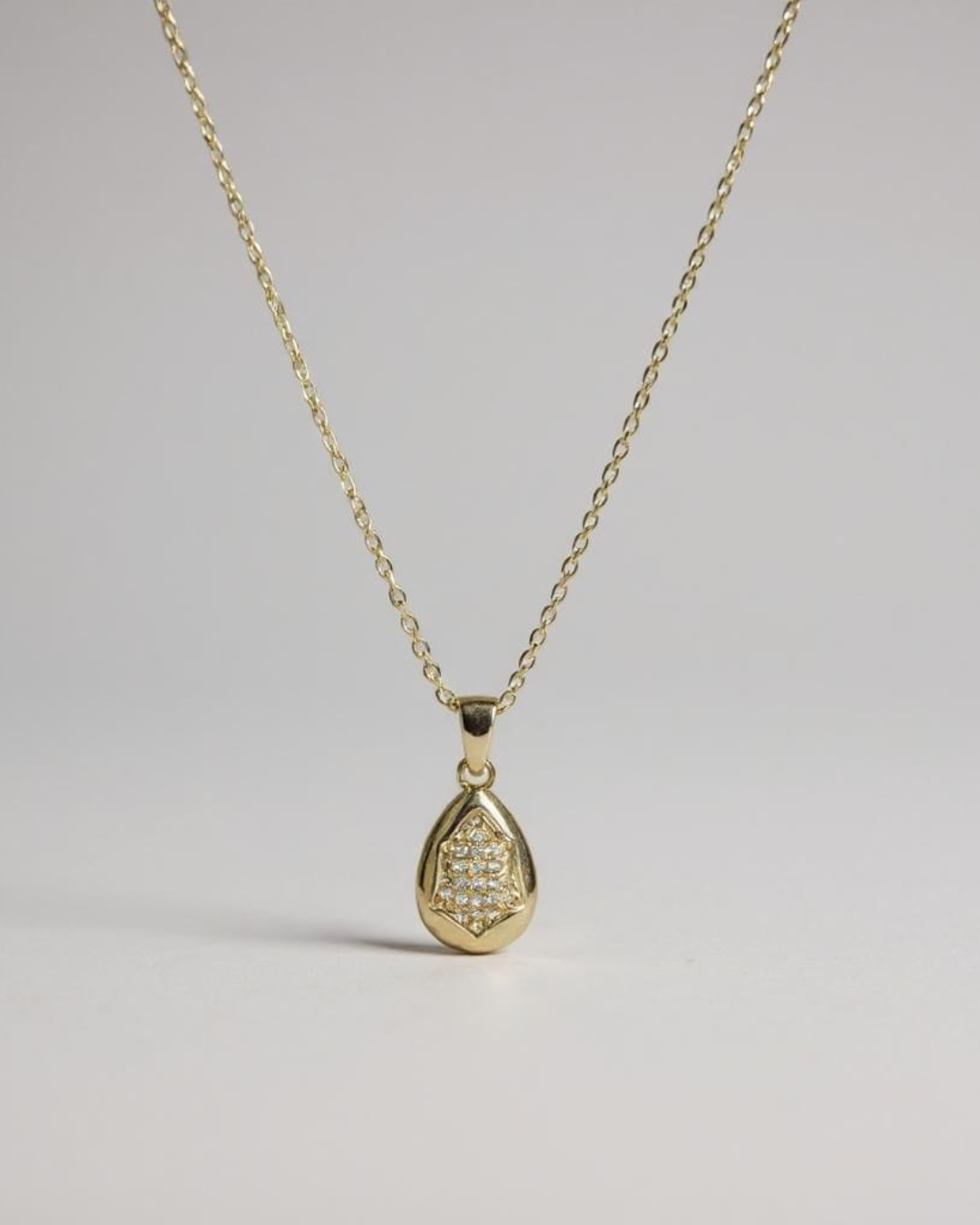 Glow Within Pendant Necklace on a light gray background